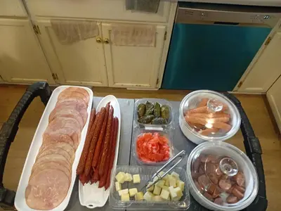 a tray of food with sausage and vegetables on a table at The Breakfast Getaway In Fraser Valley in Abbotsford