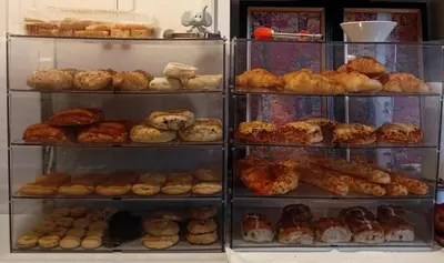 a display case filled with lots of different types of donuts at The Breakfast Getaway In Fraser Valley in Abbotsford