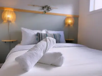 a bedroom with two white towels on a bed at Canmore Top Floor Loft-Style Retreat in Canmore