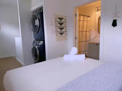 a bedroom with a bed and a washing machine at Canmore Top Floor Loft-Style Retreat in Canmore