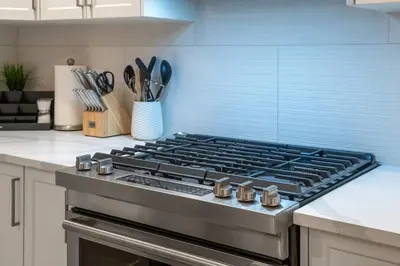 a kitchen with a stove top oven in a kitchen at Meadowstone Suite 3BD 3 TVs Near Spruce Meadows in Calgary