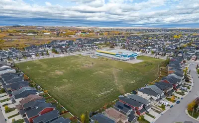 an aerial view of a parking lot with a park at Meadowstone Suite 3BD 3 TVs Near Spruce Meadows in Calgary