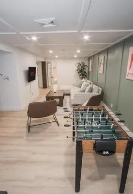 a living room with a foos ball on a table at Play & Stay - Downtown Sleeps 10 in Edmonton
