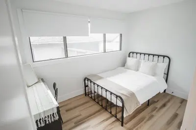 a bedroom with a bed and a window at Play & Stay - Downtown Sleeps 10 in Edmonton