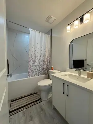 a bathroom with a toilet and a sink and a shower at 2 bedroom Basement Suite in Calgary