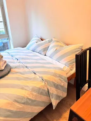 a bed in a room with a bedskirtspectspectssenalsenalsenal at Private Room in Vibrant Vancouver - with share living room and kitchen in Vancouver