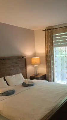 a bedroom with a bed with a lamp and a window at Private Room in Vibrant Vancouver - with share living room and kitchen in Vancouver