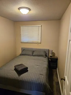 a bedroom with a bed with a pillow on it at Cozy Bungalow