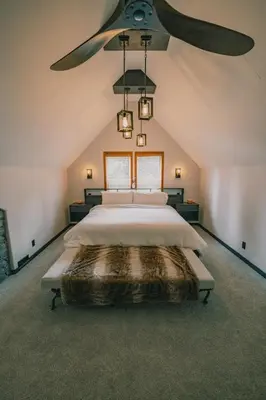 a bedroom with a large bed with a ceiling fan at Snow Reason A in Big White