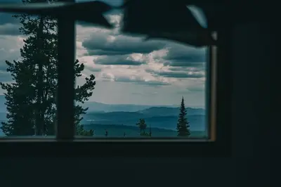 a window with a view of trees and mountains at Snow Reason A in Big White