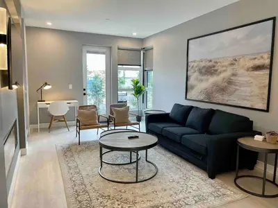 a living room with a couch and a table at Parksville Townhome 2 bedroom pool gym in Parksville