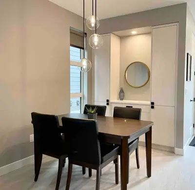 a dining room table with black chairs and a mirror at Parksville Townhome 2 bedroom pool gym in Parksville