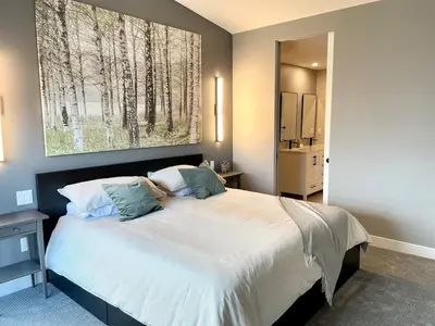 a bedroom with a bed and a painting on the wall at Parksville Townhome 2 bedroom pool gym in Parksville