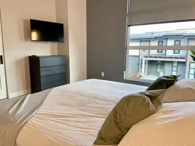 a bedroom with a bed with pillows and a window at Parksville Townhome 2 bedroom pool gym in Parksville
