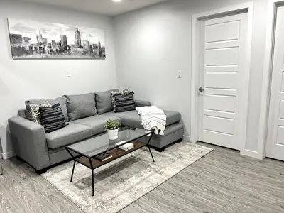 a living room with a couch and a coffee table at 1-BR Suite with Private entrance near Restaurants, Shops, Local Amenities in Edmonton