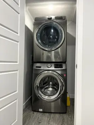 a washer and dryer in a small room at 1-BR Suite with Private entrance near Restaurants, Shops, Local Amenities in Edmonton