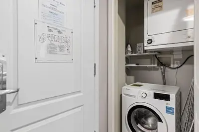a washer and dryer in a small room at 2BR in Deer Lodge, Epic Location, Private Covered Patio, Free Parking in Whistler