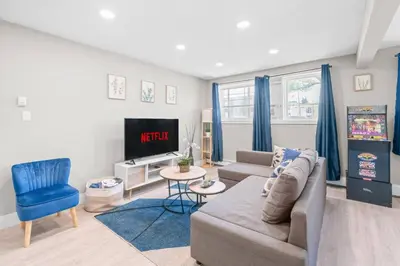 a living room with a couch and a tv at Elegant Living in a 1-Bedroom Suite in Edmonton
