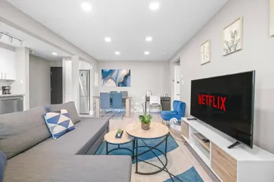 a living room with a couch and a tv at Elegant Living in a 1-Bedroom Suite in Edmonton