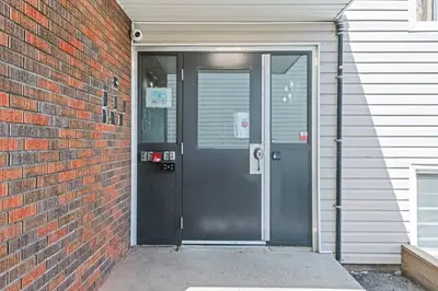 a door of a building with a brick wall at Elegant Living in a 1-Bedroom Suite in Edmonton