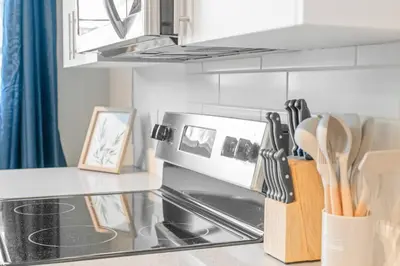 a kitchen with a counter top with a microwave at Elegant Living in a 1-Bedroom Suite in Edmonton