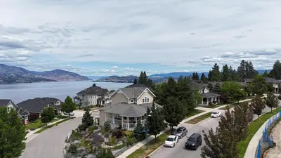 arial view of a residential neighbourhood with a lake at SHARED Lakeview Peaceful 2BR Stay in Beautiful Kelowna in Kelowna