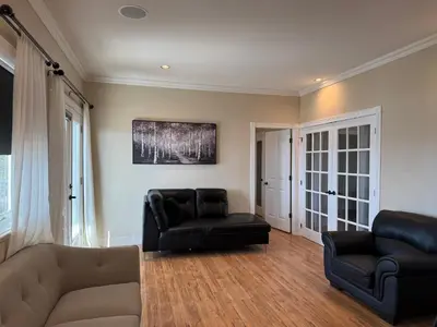 a living room with two chairs and a couch at SHARED Lakeview Peaceful 2BR Stay in Beautiful Kelowna in Kelowna