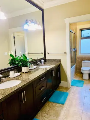 a bathroom with two sinks and a toilet at Sakura Stay two bedrooms with a private bathroom in Richmond
