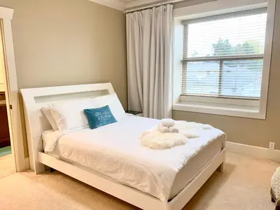 a bedroom with a white bed with a teddy bear on it at Sakura Stay two bedrooms with a private bathroom in Richmond