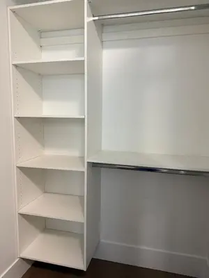 a white walk in closet with white shelves at Calm & Cozy Private Suite in Surrey