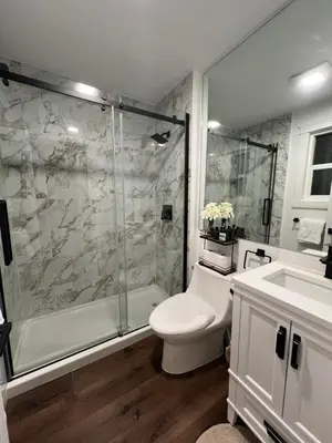 a bathroom with a shower and a toilet and a sink at LF Guesthouse in Nanaimo
