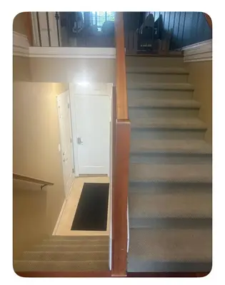 a stairway with a white door and a stair case at Lower suite in family friendly townhome in Victoria