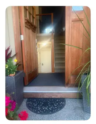 an open door of a house with a stairwell at Lower suite in family friendly townhome in Victoria
