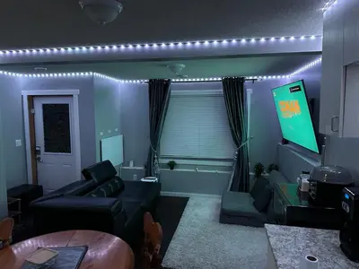 a living room with a couch and a tv at ComfyComfort in Calgary