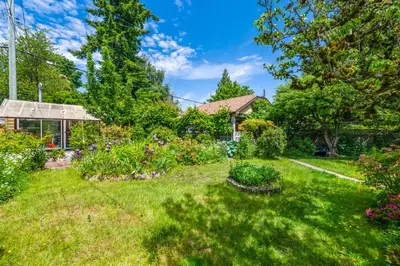 a yard with a garden of flowers and plants at Picturesque room surrounded by flowers with share spaces in Vancouver
