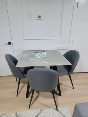 a table with two chairs and a table with a plate on it at Shiloh Residence in Edmonton