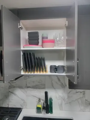 a kitchen cabinet with plates and utensils in it at Shiloh Residence in Edmonton