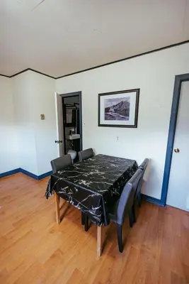 a dining room with a black table and chairs at Pet-Friendly Invermere Home with Firepit by StayIn in Lake Windermere