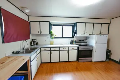 a kitchen with white cabinets and a white refrigerator at Pet-Friendly Invermere Home with Firepit by StayIn in Lake Windermere