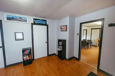 an empty living room with a door and a hard wood floor at Pet-Friendly Invermere Home with Firepit by StayIn in Lake Windermere