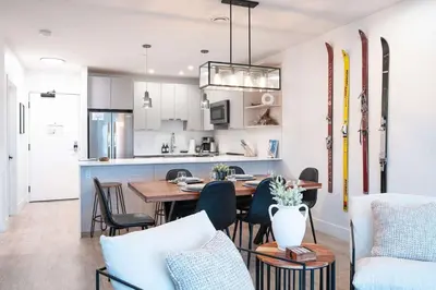 a kitchen and dining room with a table and chairs at Huckin' Harry's in Revelstoke
