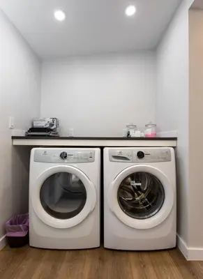 a laundry room with a washer and dryer at Cozy 1-Bedroom Retreat in the Heart of Langford in Victoria