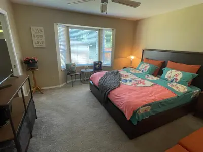 a bedroom with a bed and a television in it at Guest Suite in Maple Ridge in Maple Ridge District Municipality