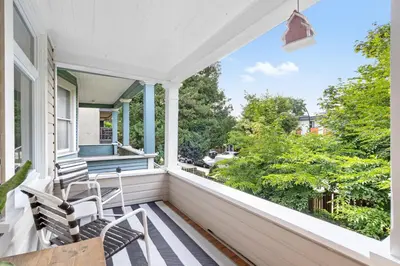 a porch with two chairs and a table at Adorable Kits Home with Balcony and Garden Retreat in Vancouver