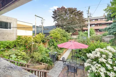 a patio with a table and an umbrella at Adorable Kits Home with Balcony and Garden Retreat in Vancouver