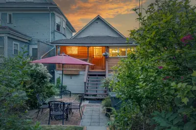 a house with a patio with a table and chairs at Adorable Kits Home with Balcony and Garden Retreat in Vancouver