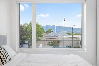 a large window with a view of a building at Duplex in West Point Grey with Parking and Balcony in Vancouver