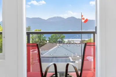 a view from a window with a canadian flag at Duplex in West Point Grey with Parking and Balcony in Vancouver
