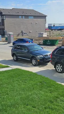 two cars are parked in a parking lot at Spruce Meadows Place in Calgary
