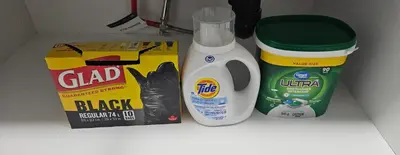 a counter with a package of bleach and a box of food at Spruce Meadows Place in Calgary